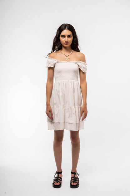 Front-facing view of white smocked midi dress with airy fit and romantic sleeve design.

