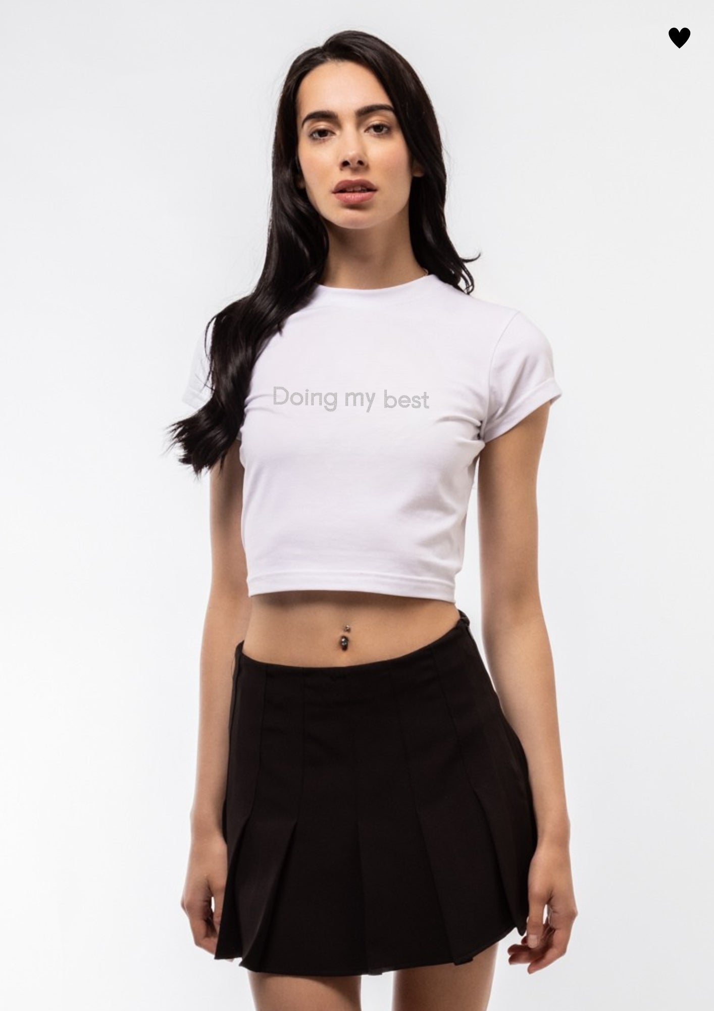 Woman wearing a white crop top with text DOING MY BEST  and a black skirt on a white background