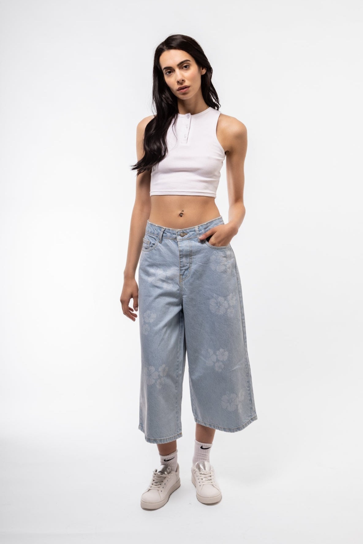 Front shot of printed denim jorts in longline cut with high waist and graphic pattern.

