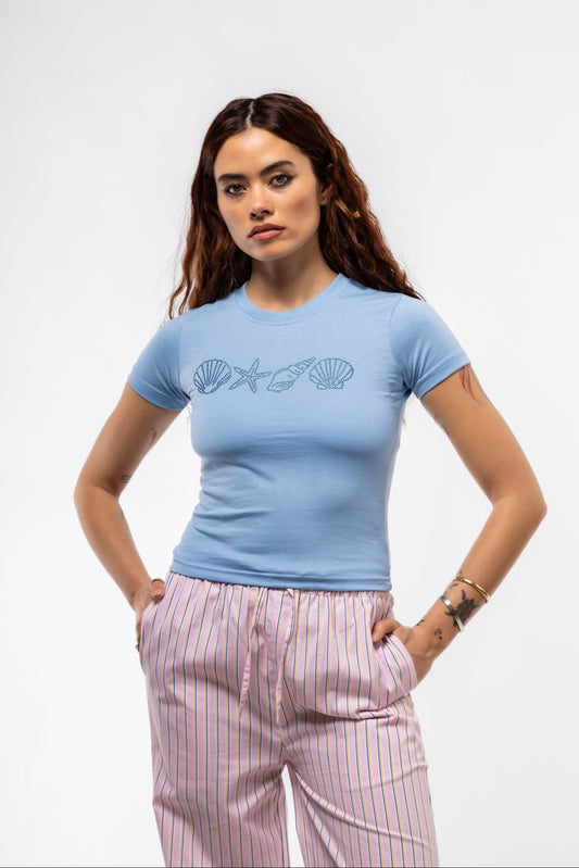 Front view of Blue Shell rhinestone tee featuring sparkling seashell design in shimmering blue stones

