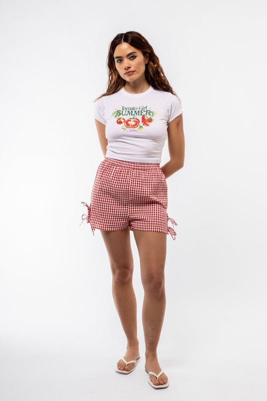 Front view of Tomato Girl graphic tee featuring playful tomato illustration and bold text

