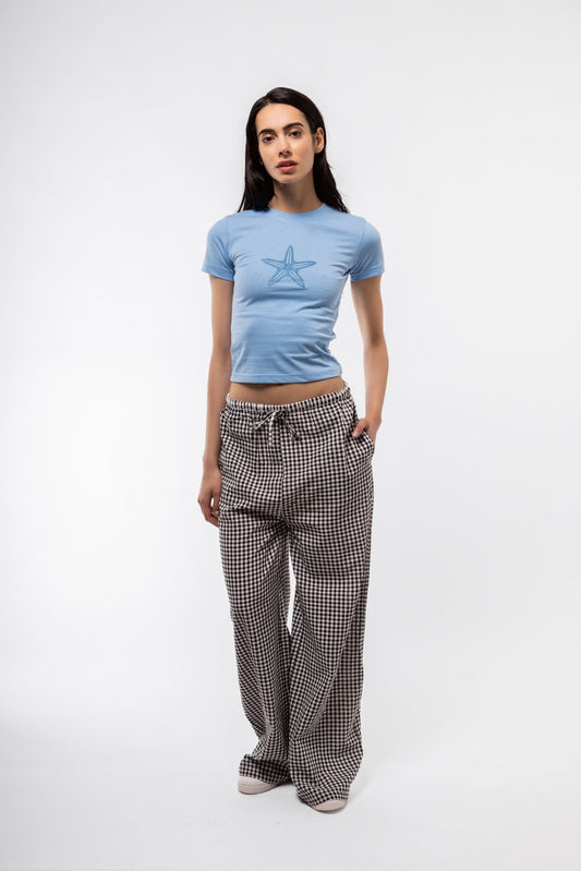 Front view of black gingham trousers with high waist and straight-leg silhouette.

