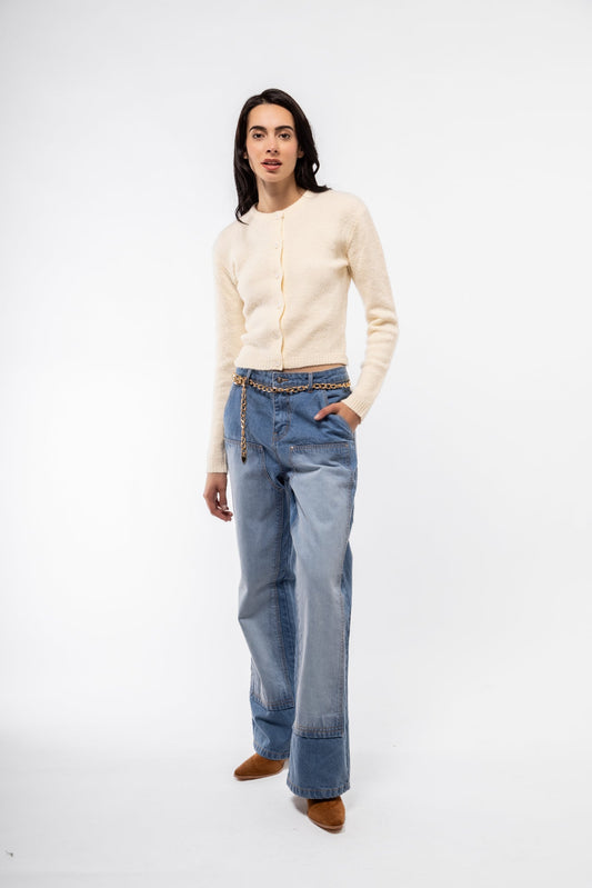 Front view of chap style wide leg jeans featuring contrast paneling and dramatic flared legs.

