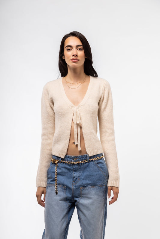 Front view of ecru tie-front knit cardigan – neutral layering essential

