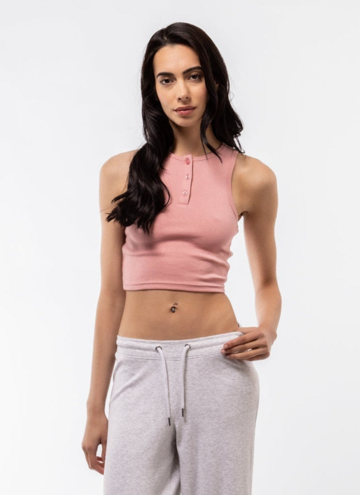 Front view of pink button placket racer top in soft pastel tone and fitted cut.

