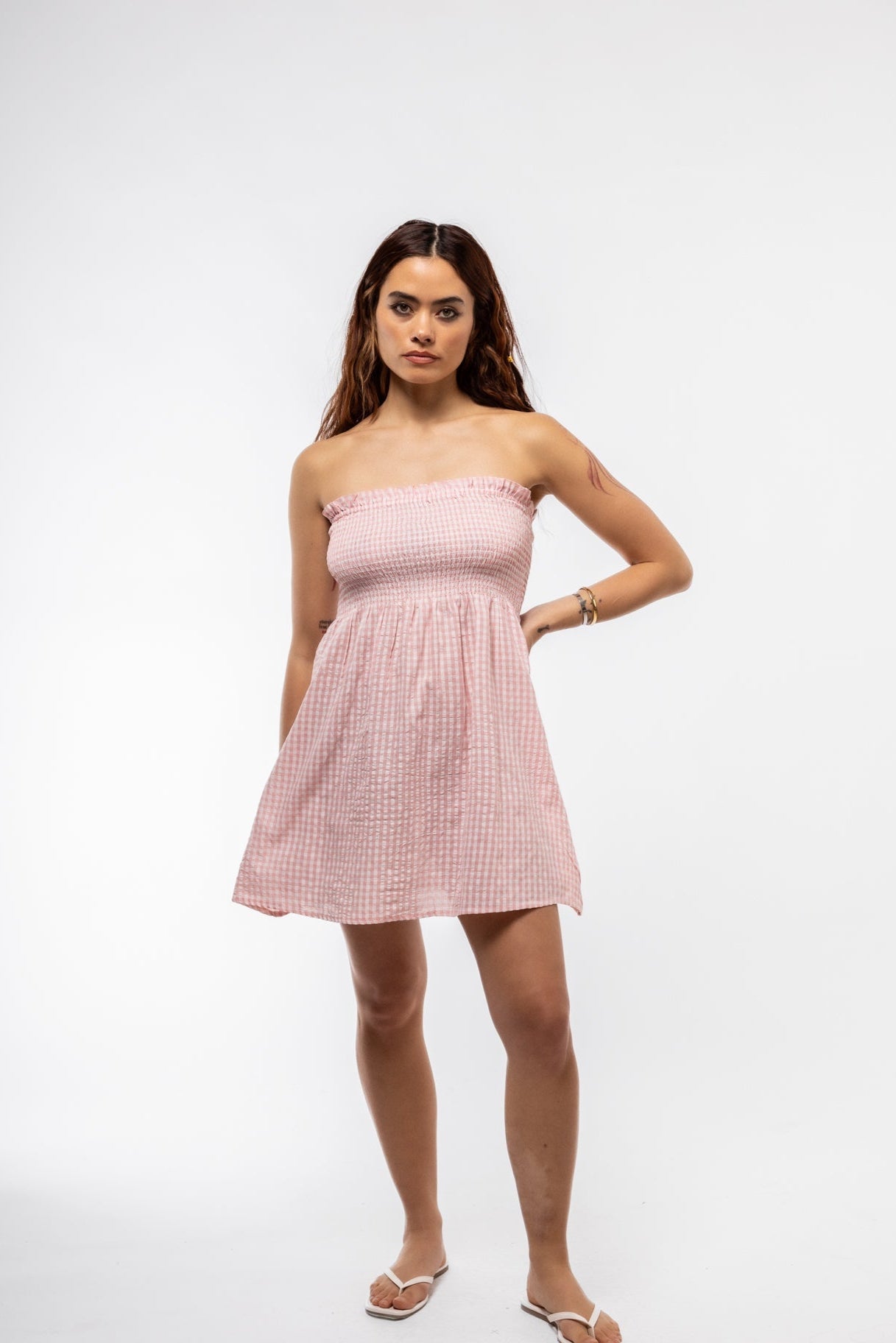 Front view of pink gingham ruched bandeau mini dress – summer style

