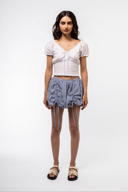 Front view of the blue gingham skirt with tie details 