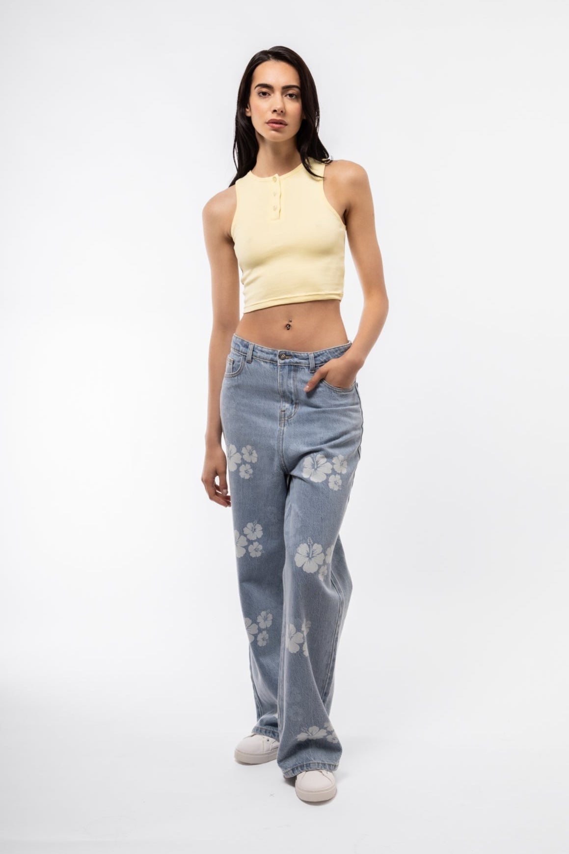 Lemon-toned sleeveless top with fitted body and front buttons, casual style.

