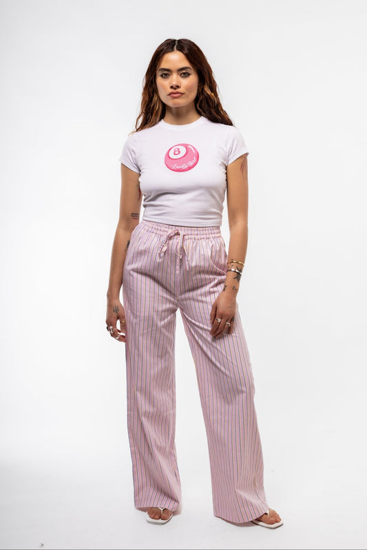 Front view of women’s pink striped cotton trousers with drawstring waist and casual loose fit.

