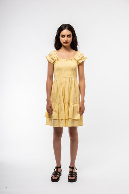 Light yellow cotton tea dress for women with shirring detail and relaxed fit, shown front-on.

