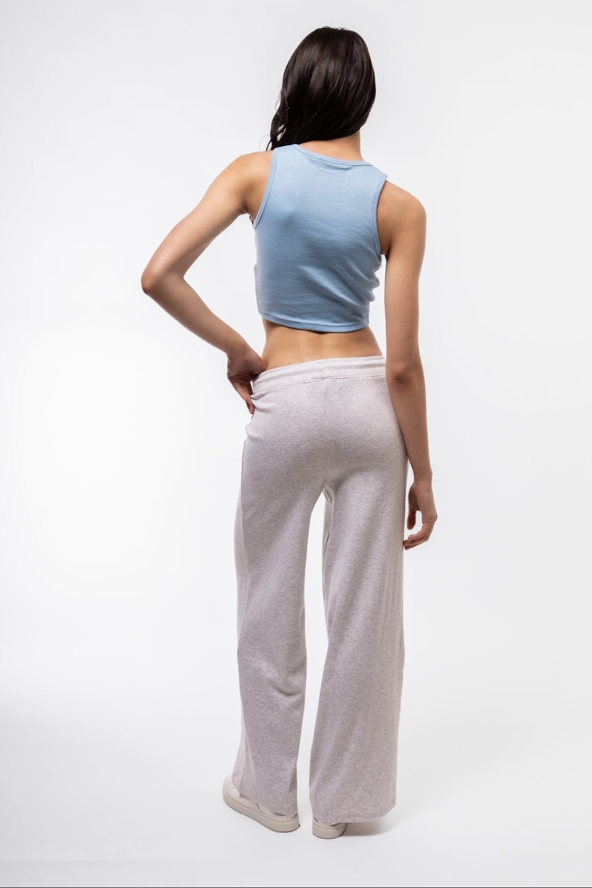 Rear image of sky blue racer top with cropped length and sleek back panel.

