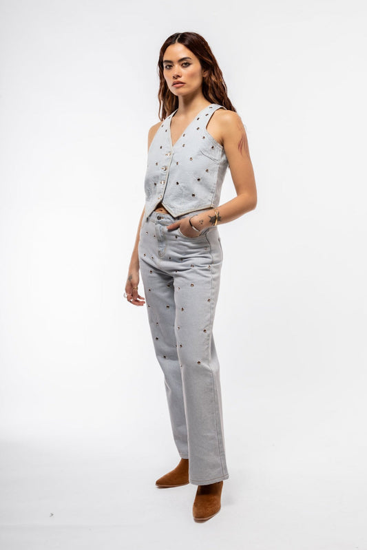 Front view of studded denim waistcoat featuring silver-tone stud detailing and button-down closure

