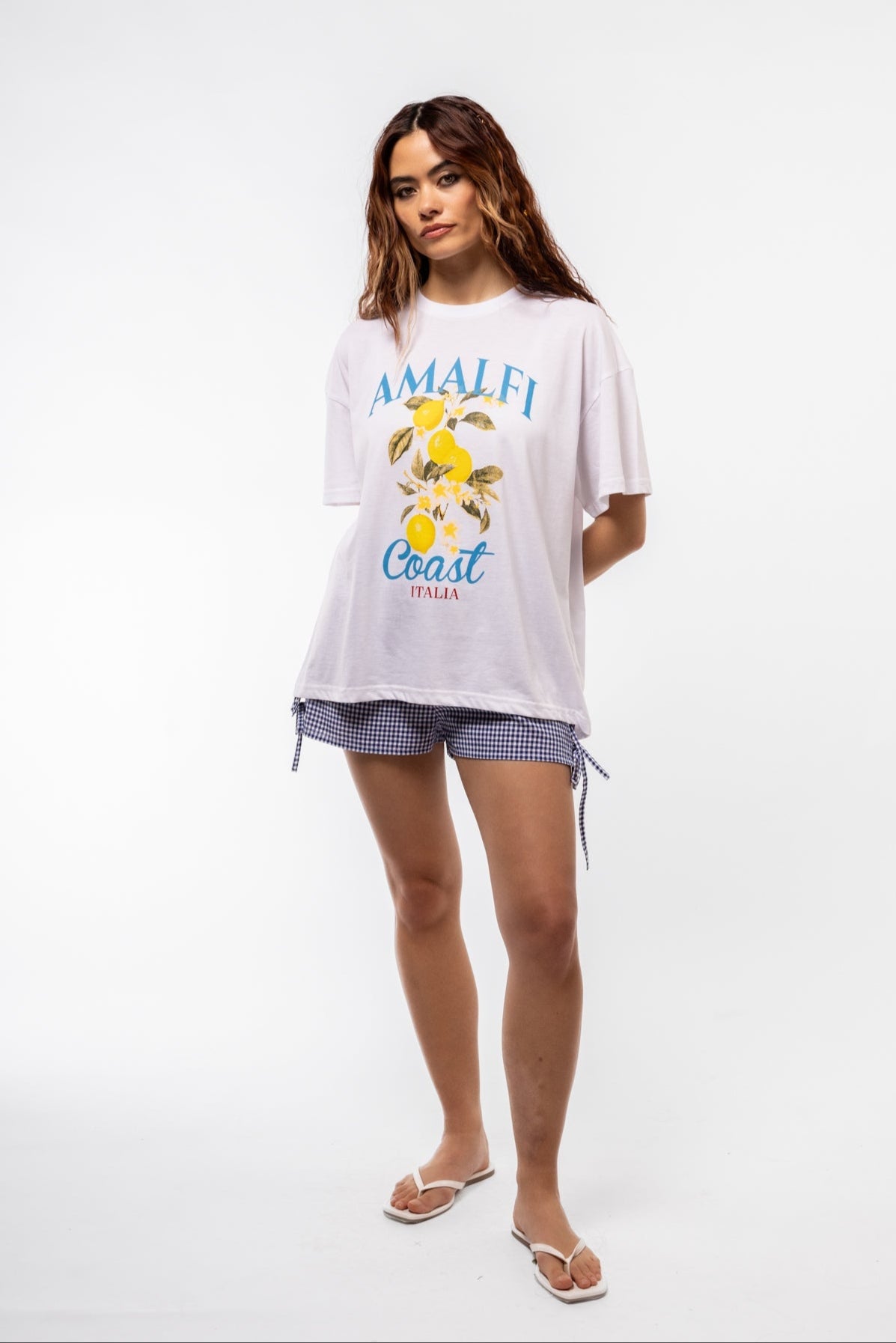 Model wearing Amalfi oversized tee with Mediterranean graphic and casual streetwear styling

