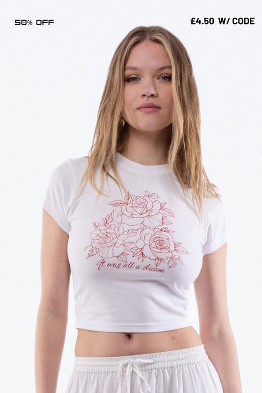 Woman wearing a white t-shirt with floral design and text on a white background