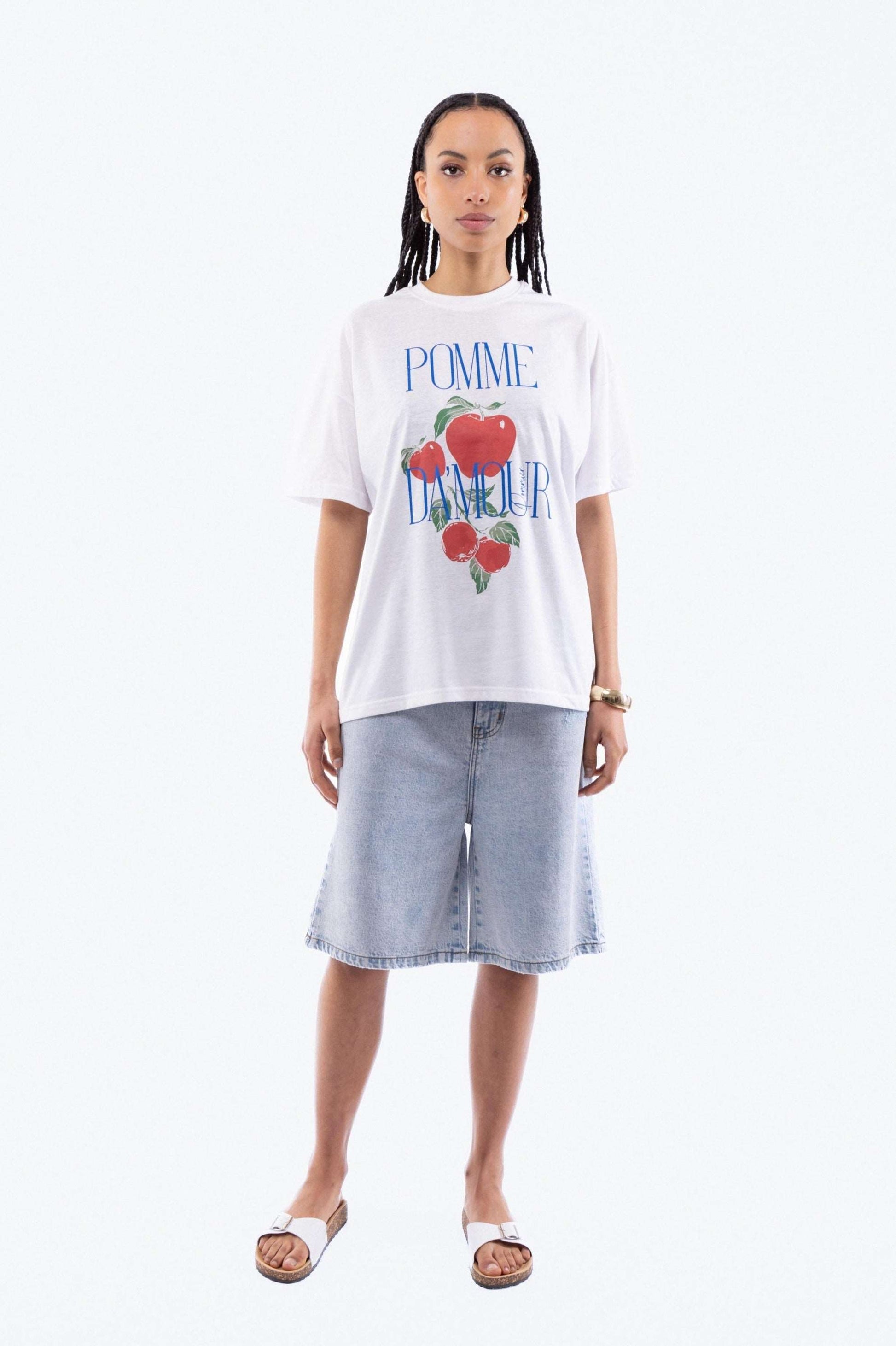 a woman in a oversized tee posing with a graphic print  top from silkroad daughters