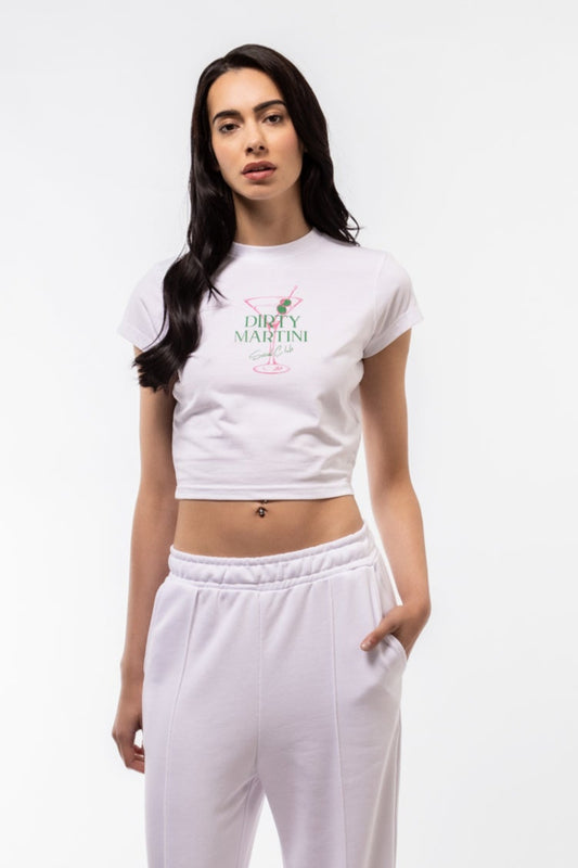 Person wearing a white t-shirt WITHA GRAPHIC DIRTY MARTINI  and pants on a white background