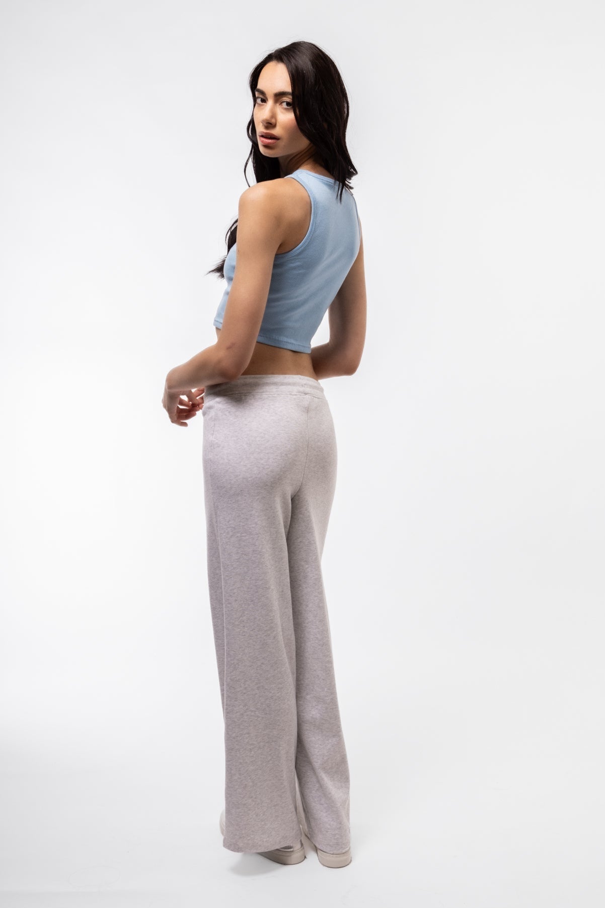 Rear image of sky blue racer top with cropped length and sleek back panel.

