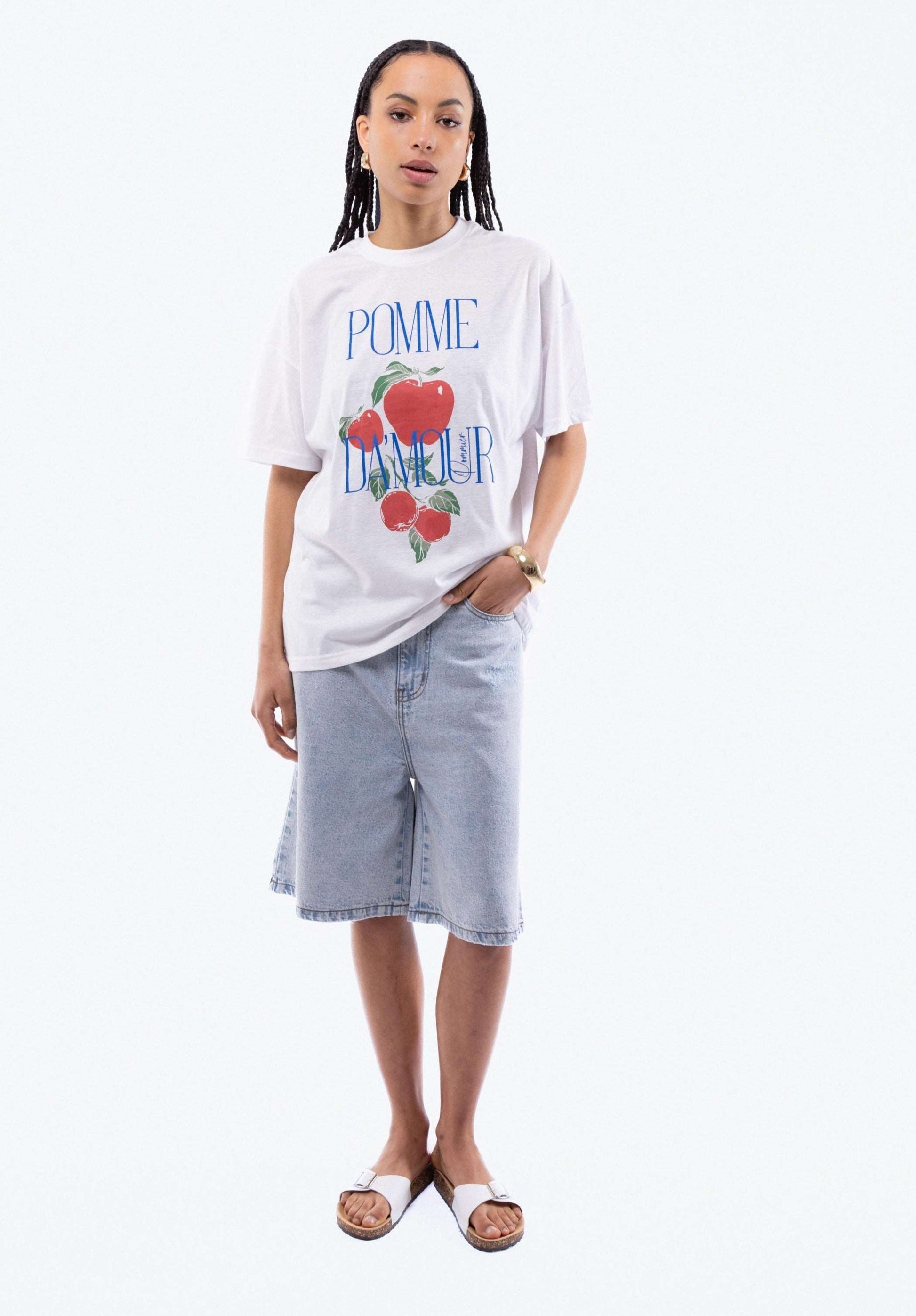 a woman in a oversized top posing with a pomme d amour top from silkroad daughters 