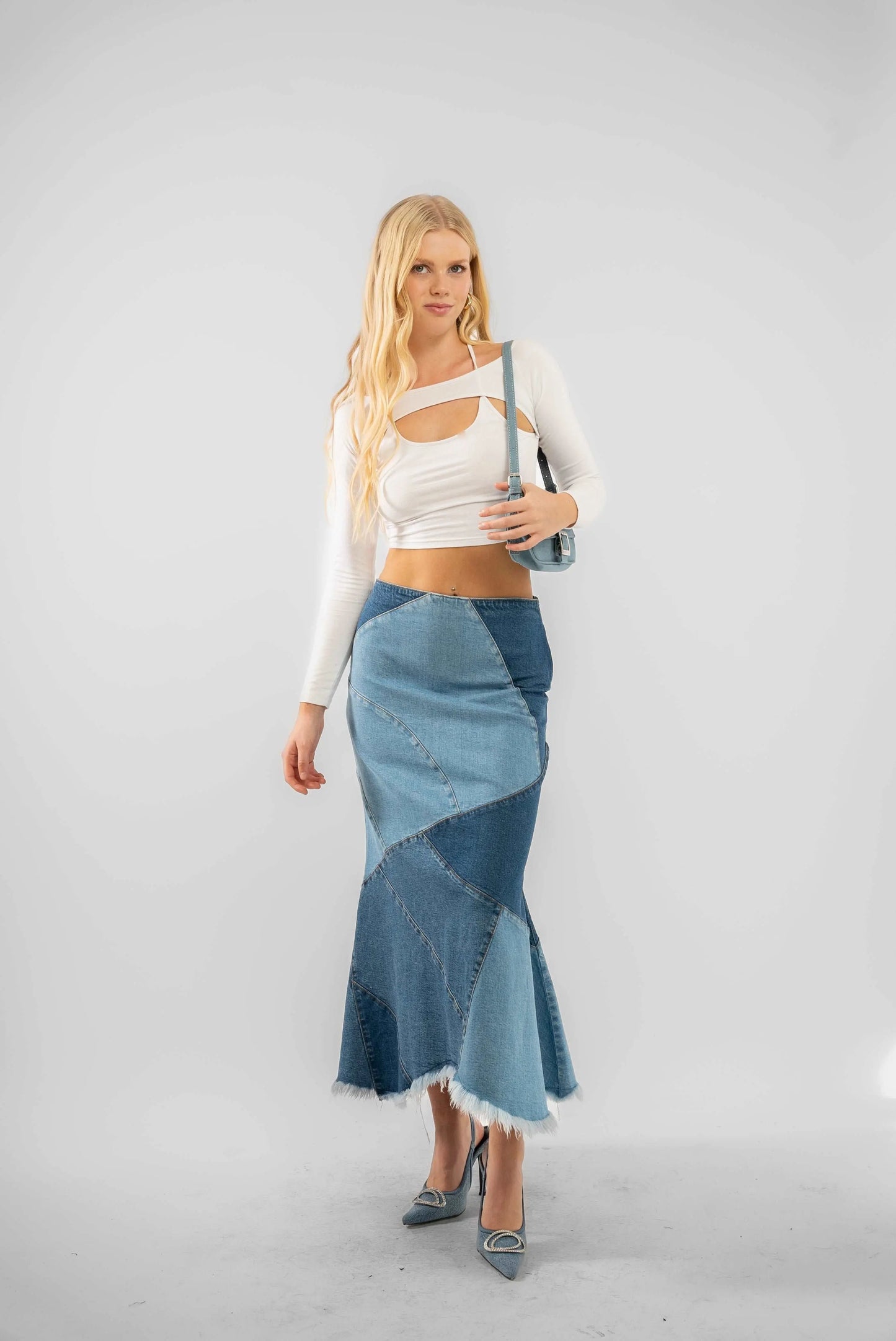 a woman in a white top and a blue skirt