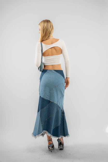 a woman posing in a skirt with a back cut out