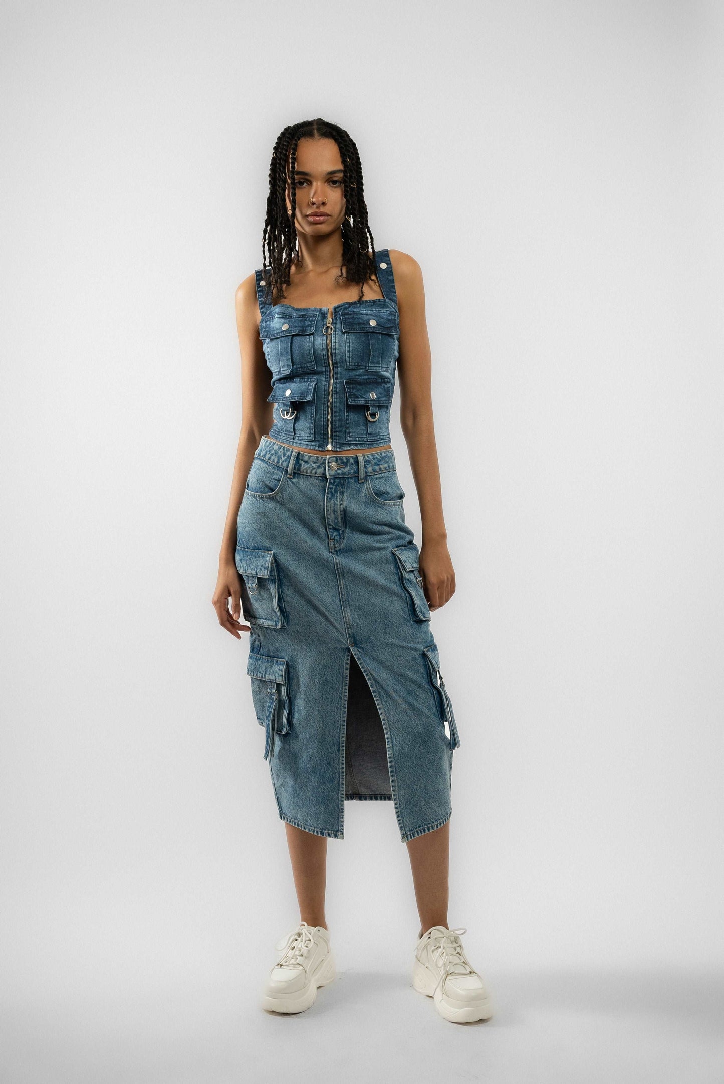 a woman wearing a denim skirt and a tank top