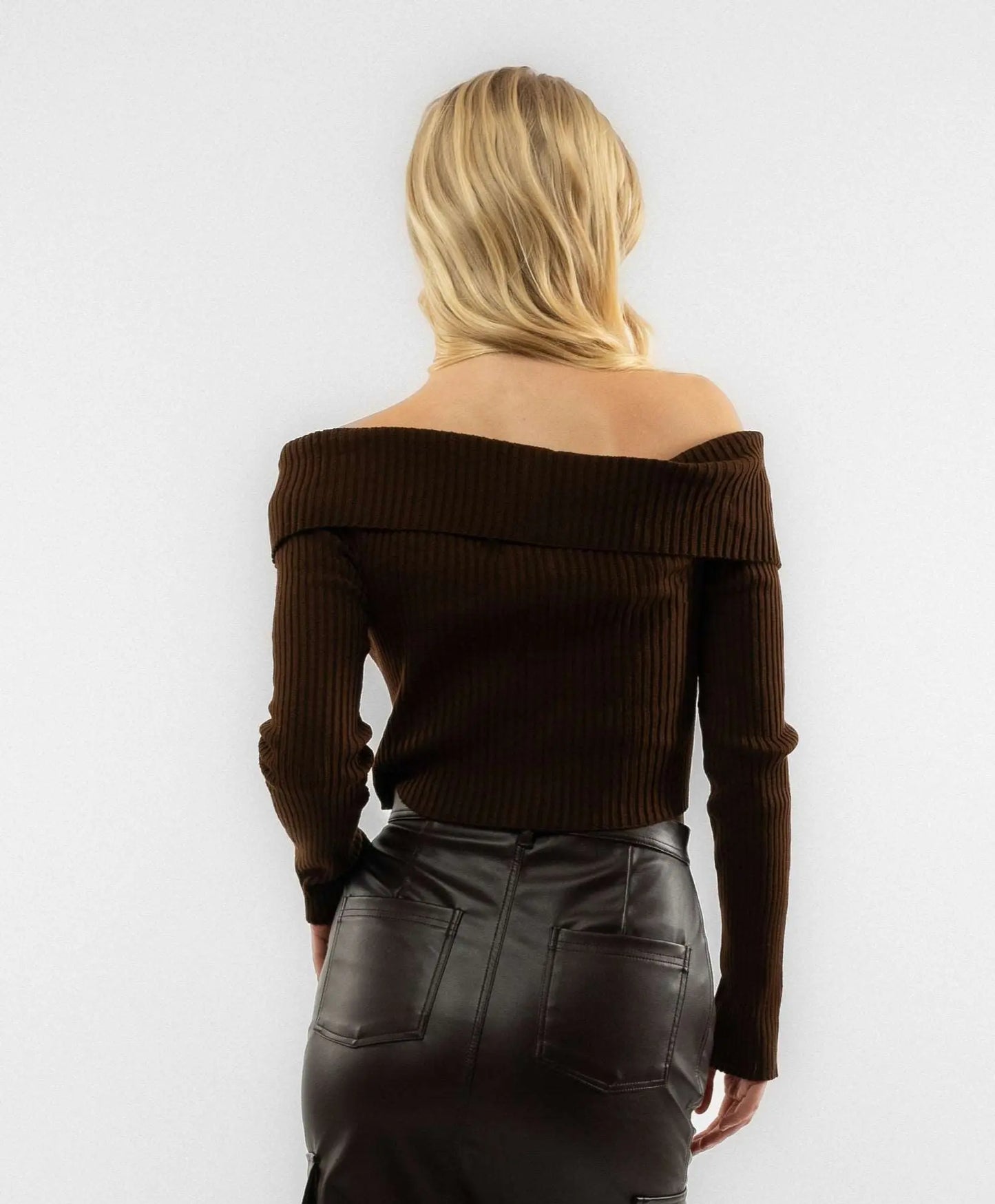 a woman wearing a brown knitted zip through top 