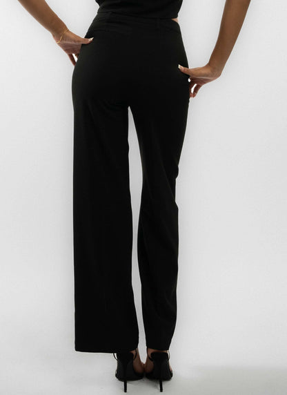 a woman wearing a black tailored wide leg trouser posing