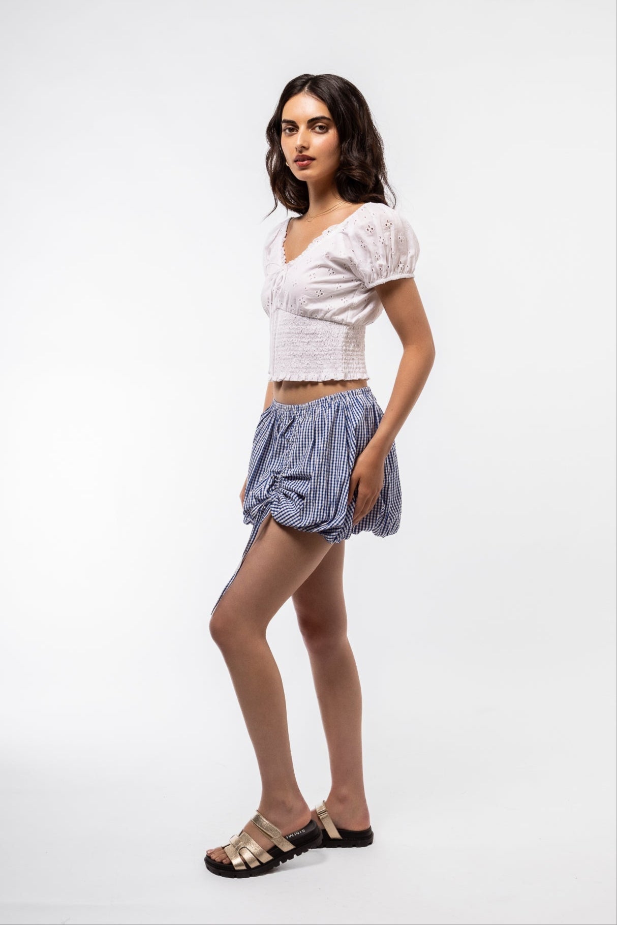 Side Profile View of the blue gingham skirt with tie detail on the skirt 