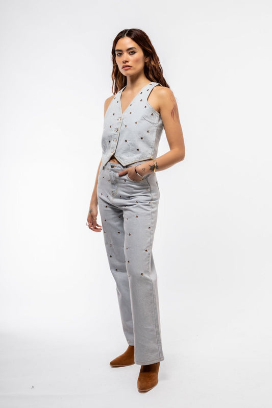 Side profile of studded wide leg jeans highlighting loose leg cut and shiny hardware accents

