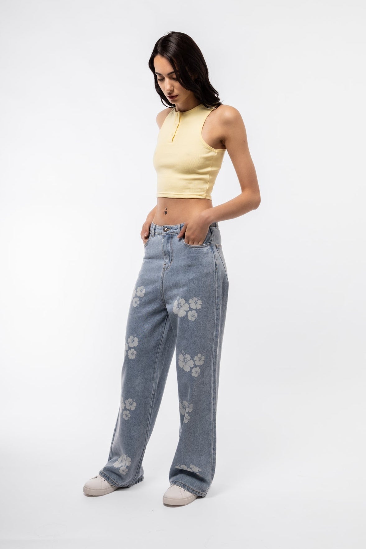 Side profile of wide leg jeans in printed denim with clean seam lines and relaxed fit.

