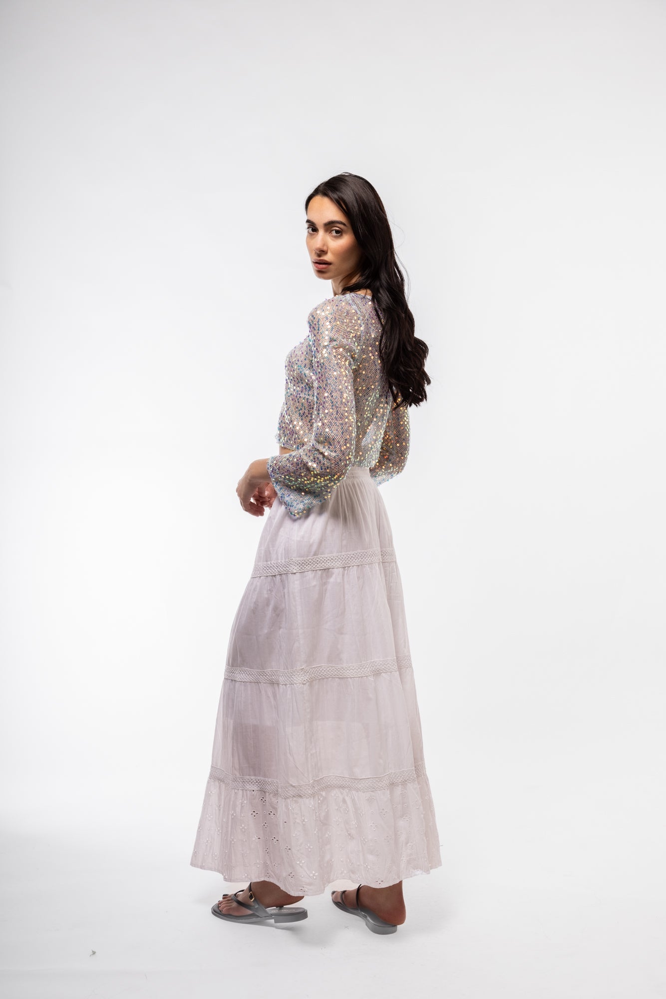 Side view of sequin crochet knit top – elegant sparkle and breezy fit

