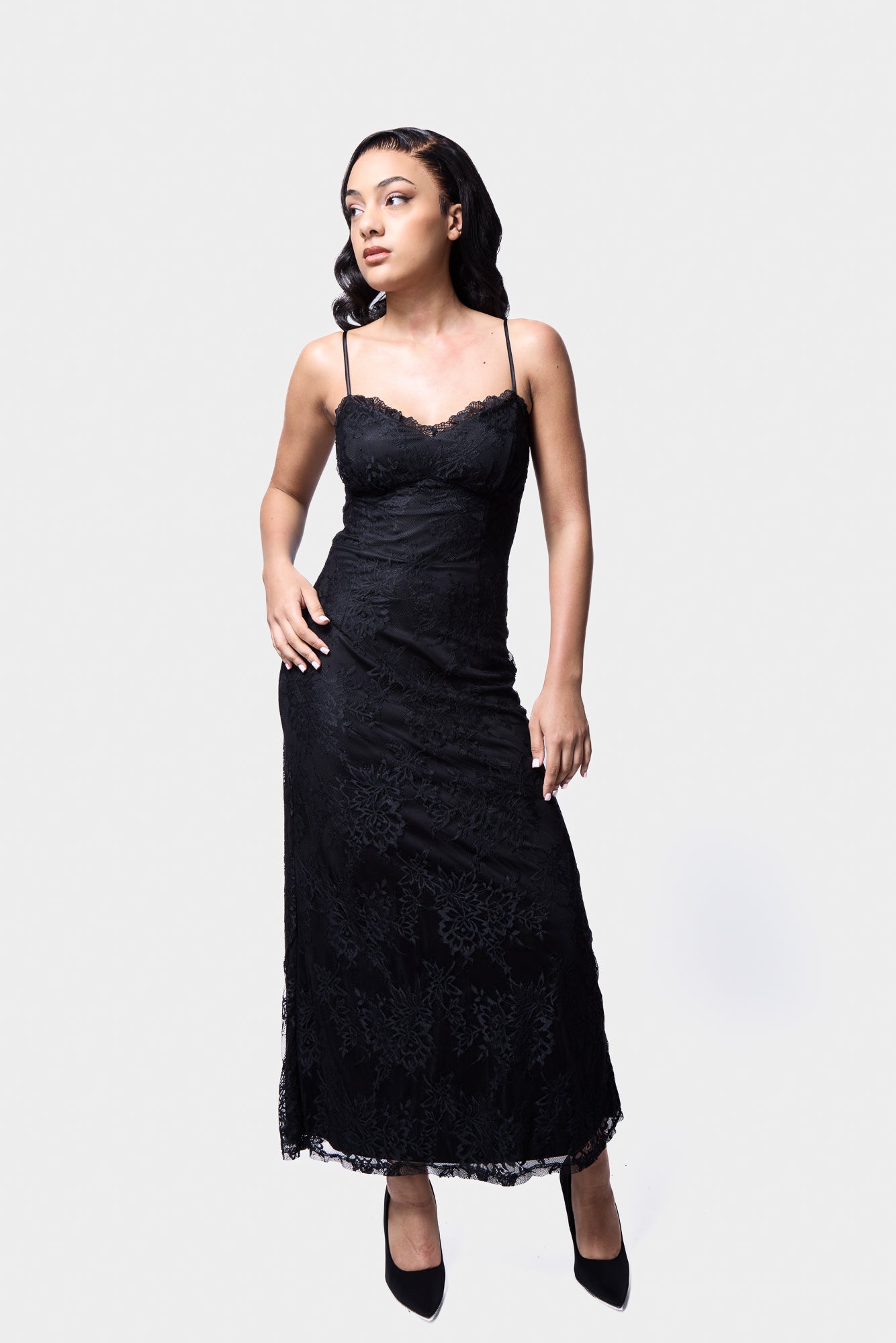 Sleek black lace midi slip dress with a body-skimming silhouette and lace trim