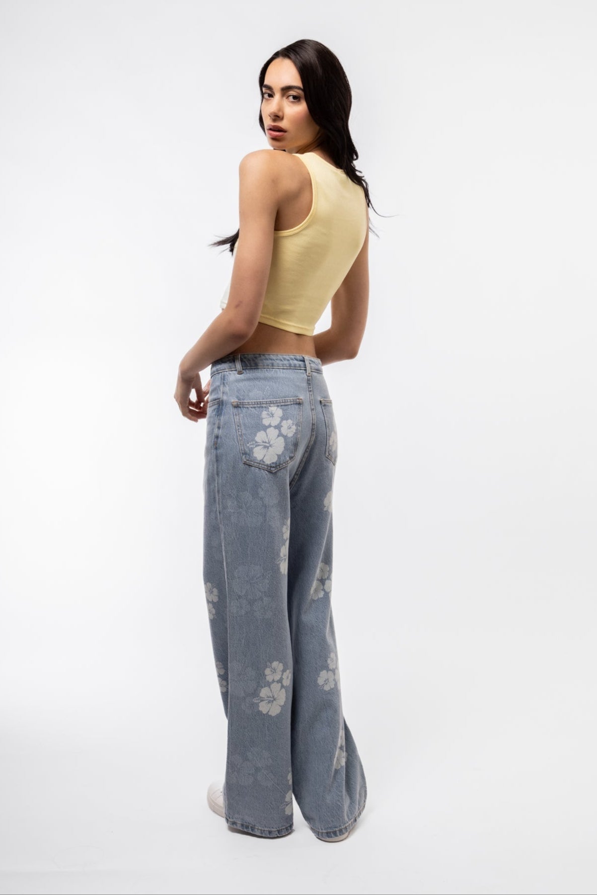 Soft yellow racer top with front buttons and racer cut, side image.

