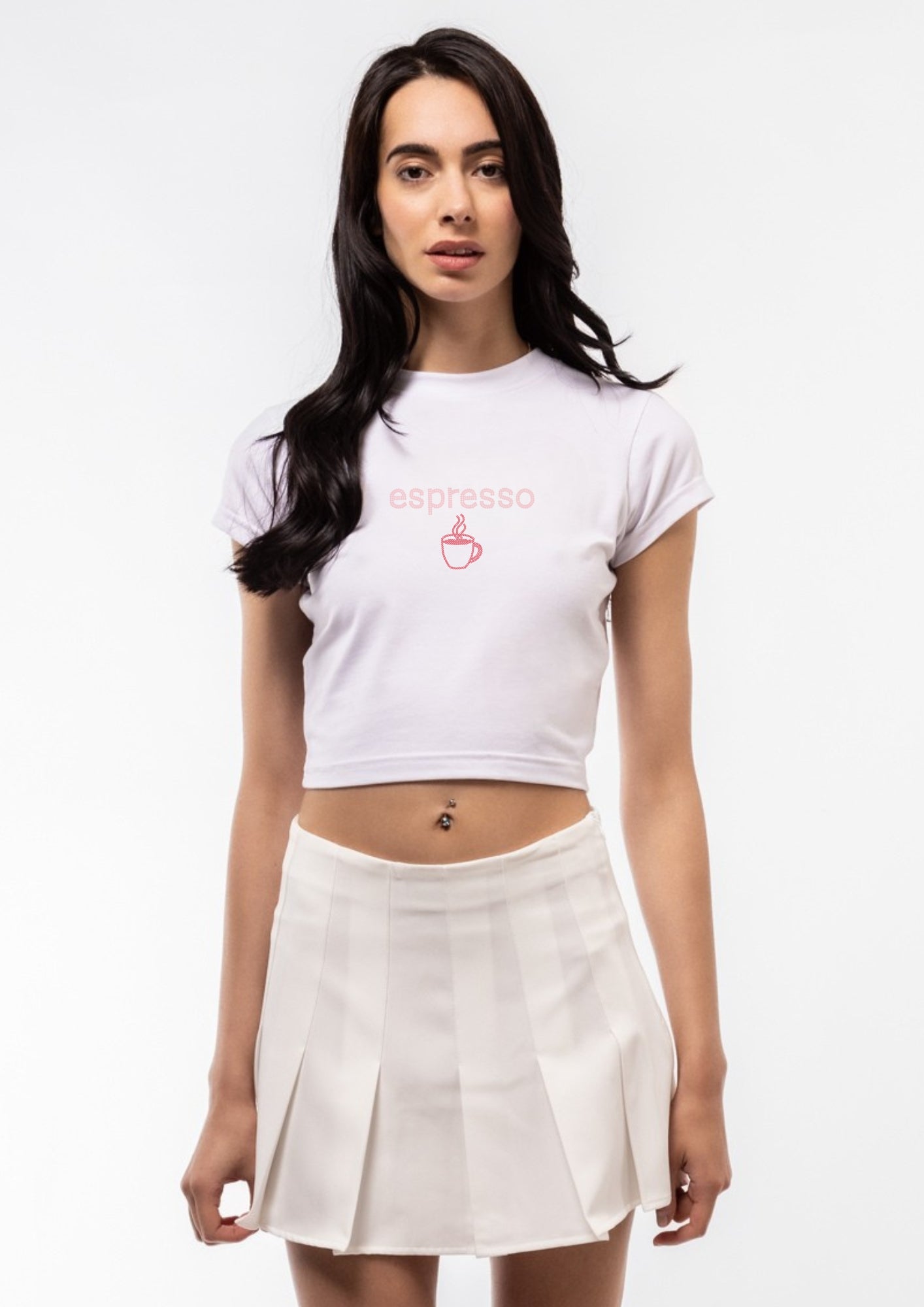 Woman wearing a white t-shirt with a logo and a beige skirt on a white background