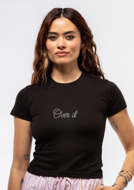 Woman wearing a black t-shirt with 'Over it' text on a plain background