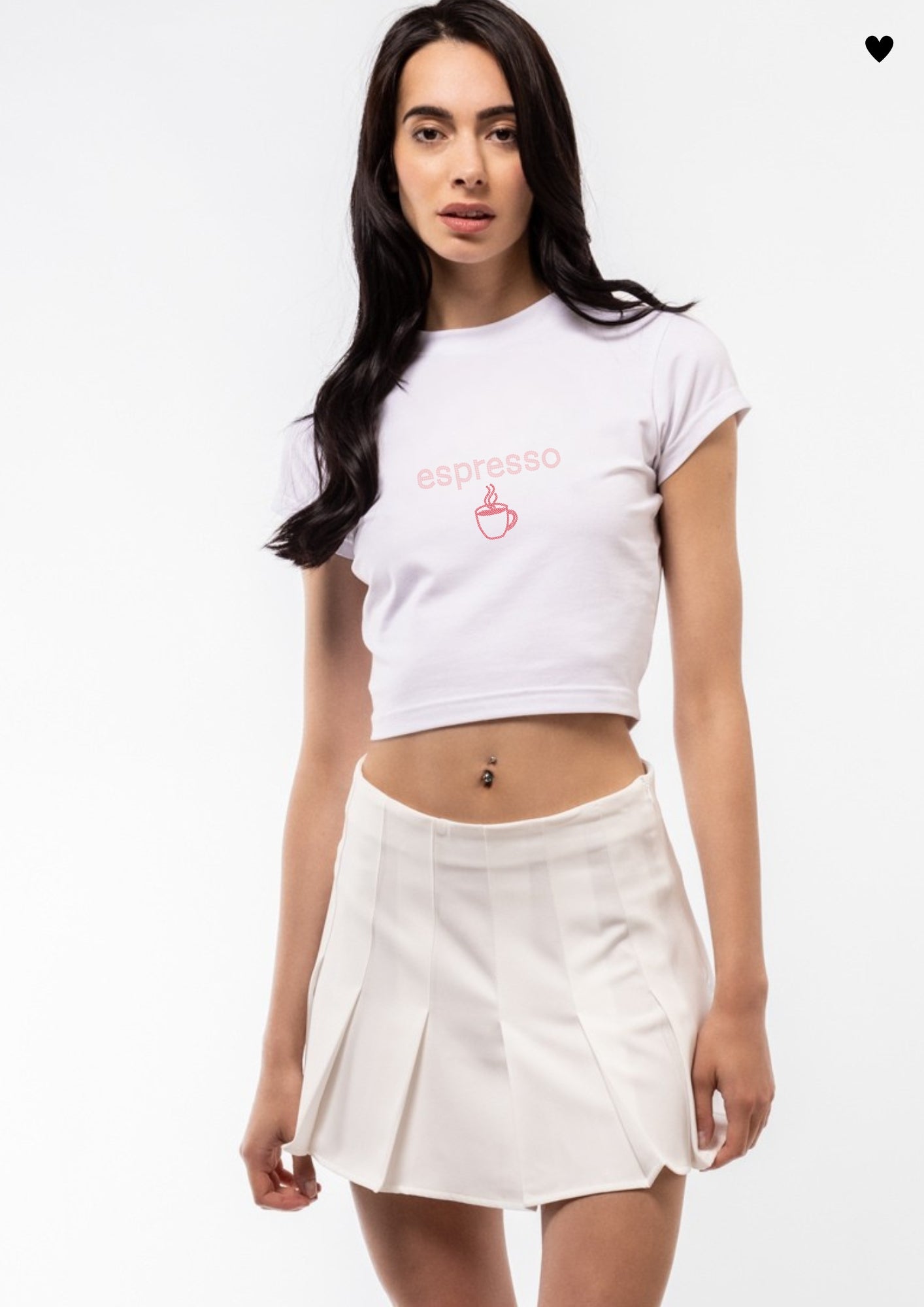 Woman wearing a white t-shirt with 'espresso' text and a red coffee cup graphic, paired with a white skirt on a light gray background.