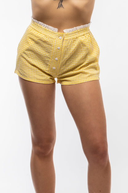 Women's pastel yellow shorts with a clean front silhouette

