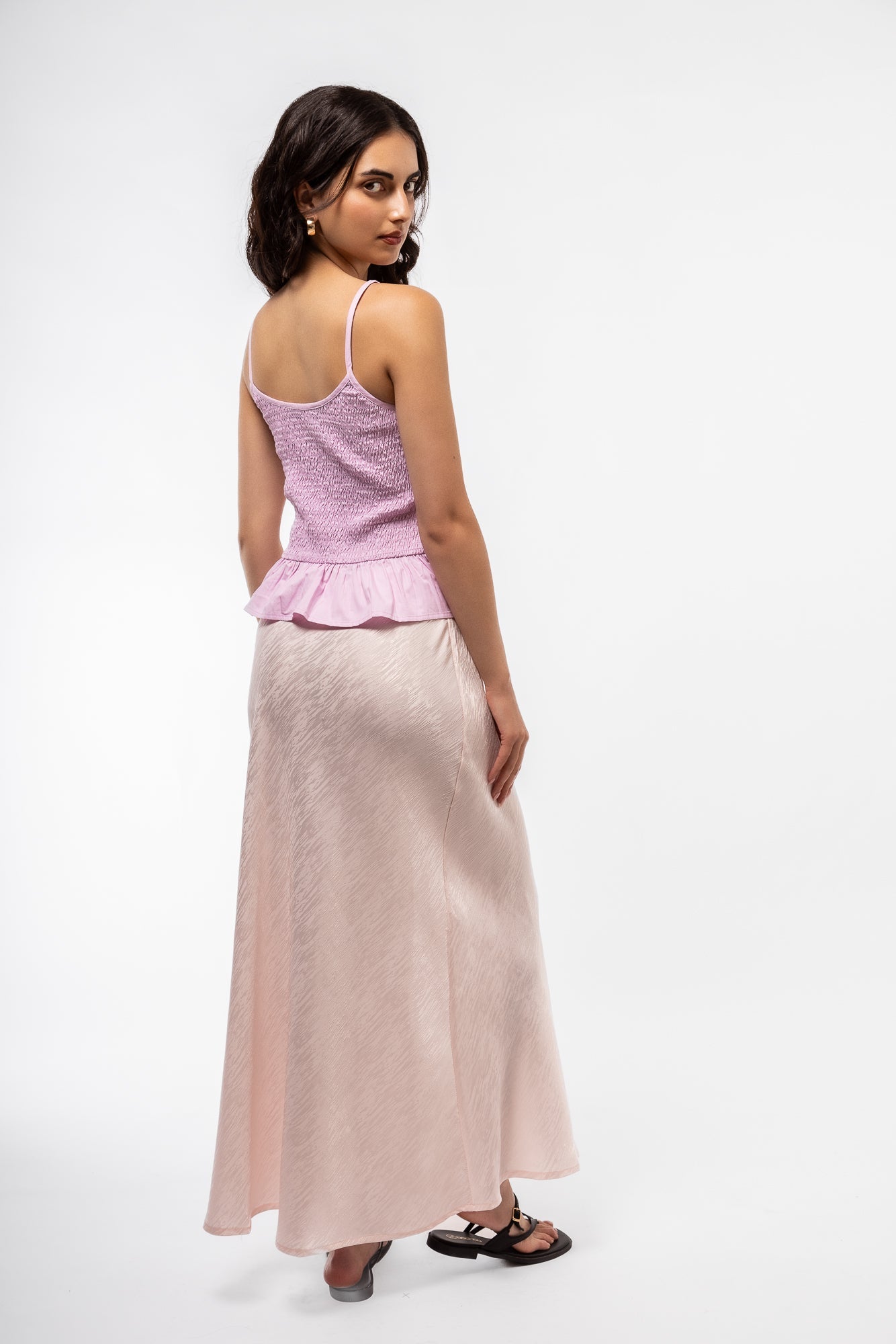 back side profile of model wearing the shirring bow tank top 