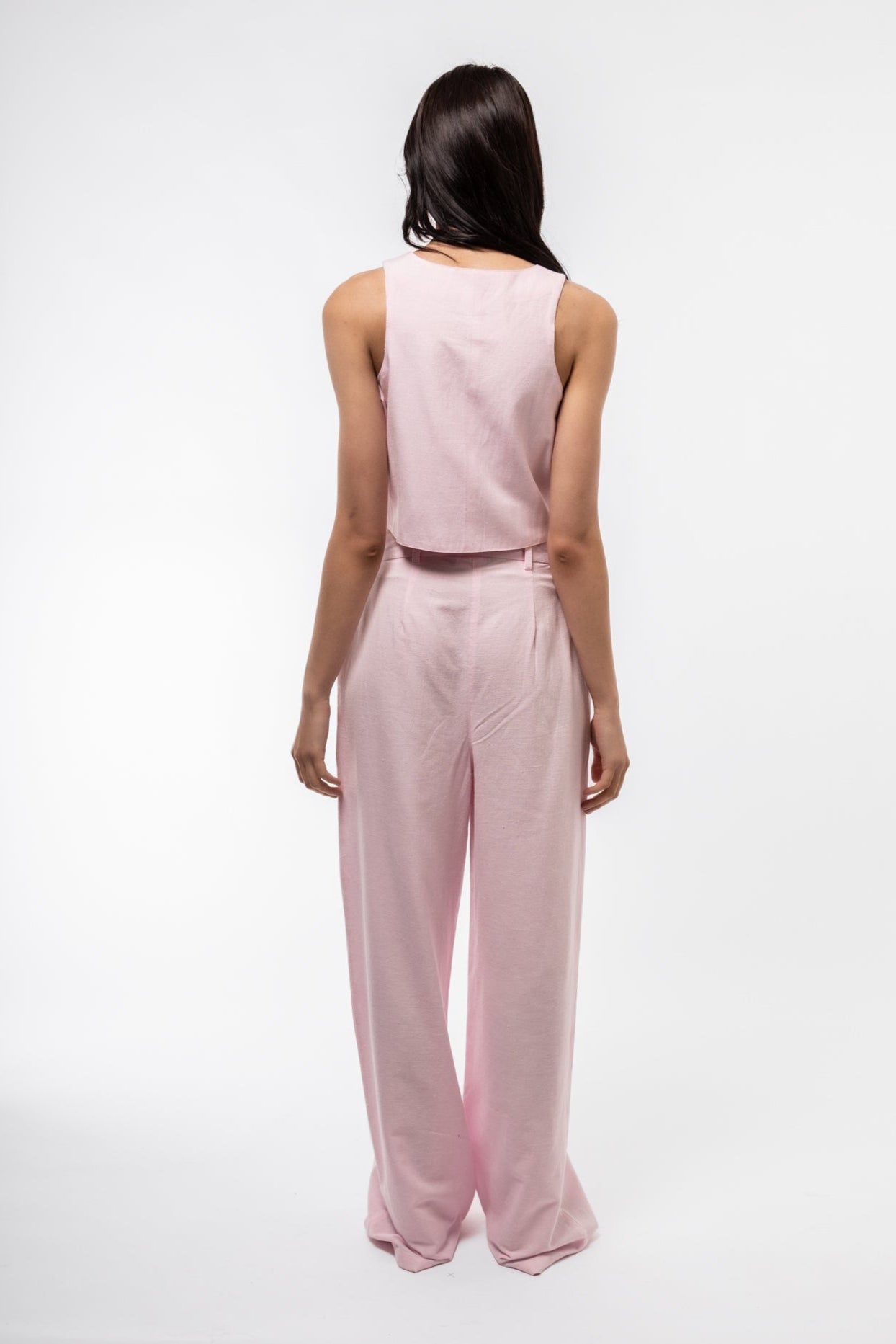 back view of the pink woven waistcoat with model wearing a vest with linen blend 