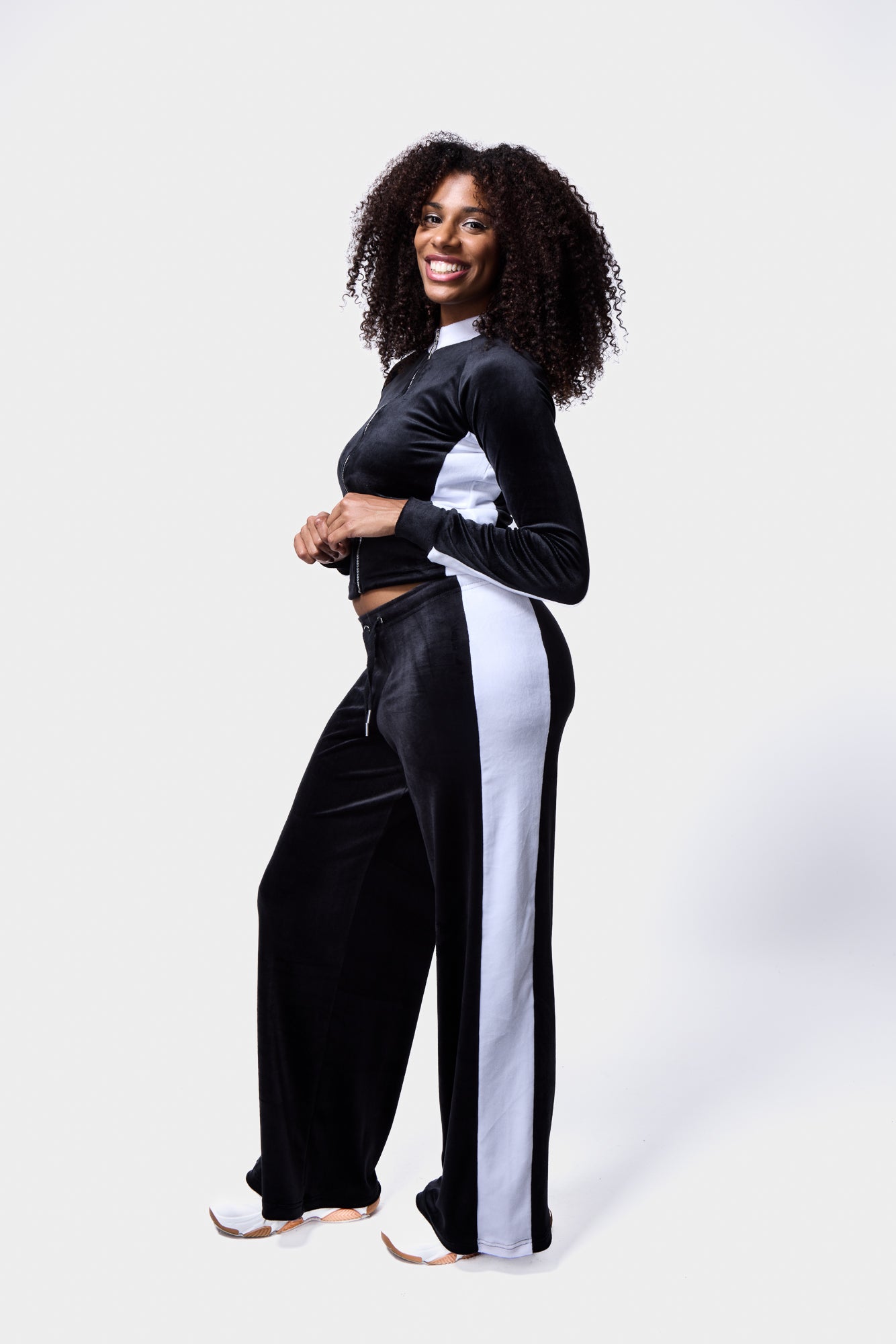 Model in contrast panel velour tracksuit in black and white