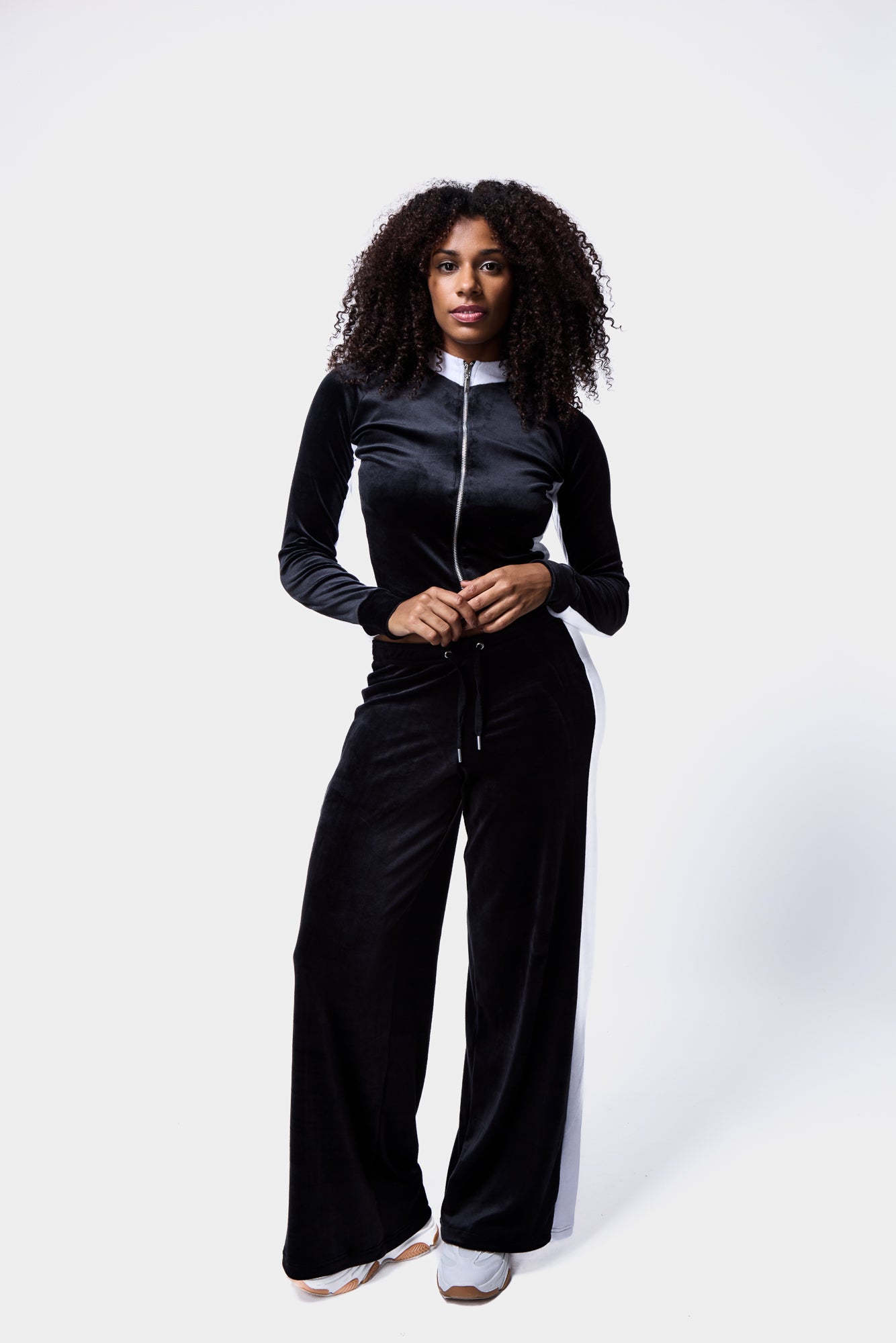 Model in contrast panel velour tracksuit in black and white