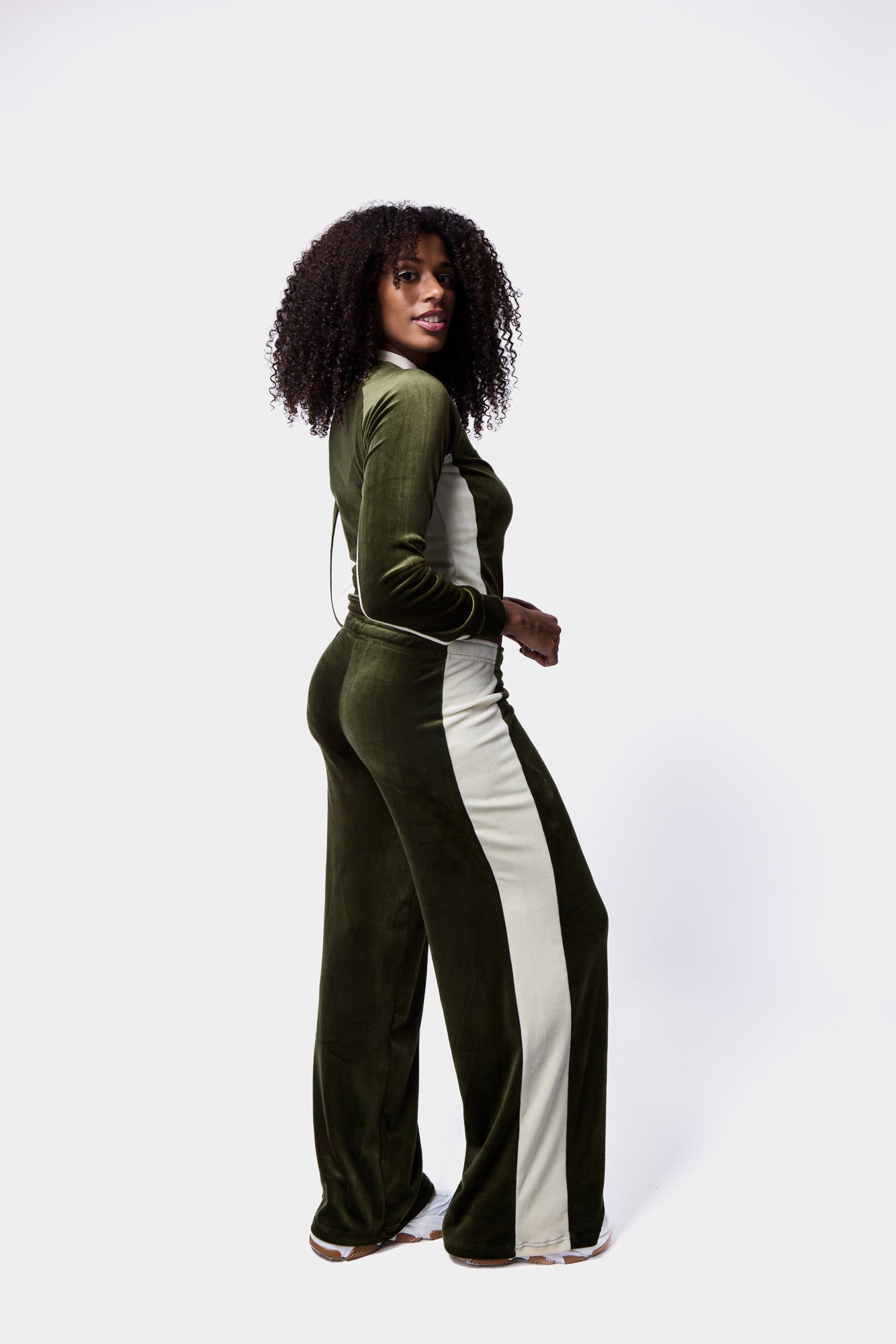 Model wearing contrast panel velour tracksuit in green and white