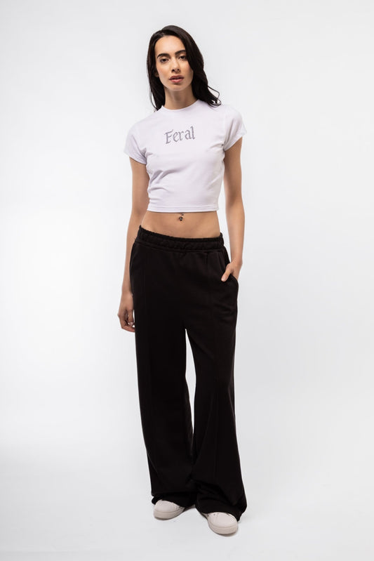 Front view of Feral rhinestone baby tee featuring sparkling rhinestone lettering and fitted cropped cut

