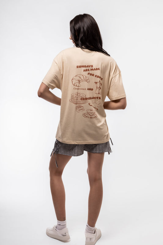Back view of Sundays and Croissants oversized tee with clean solid back and extended sleeves

