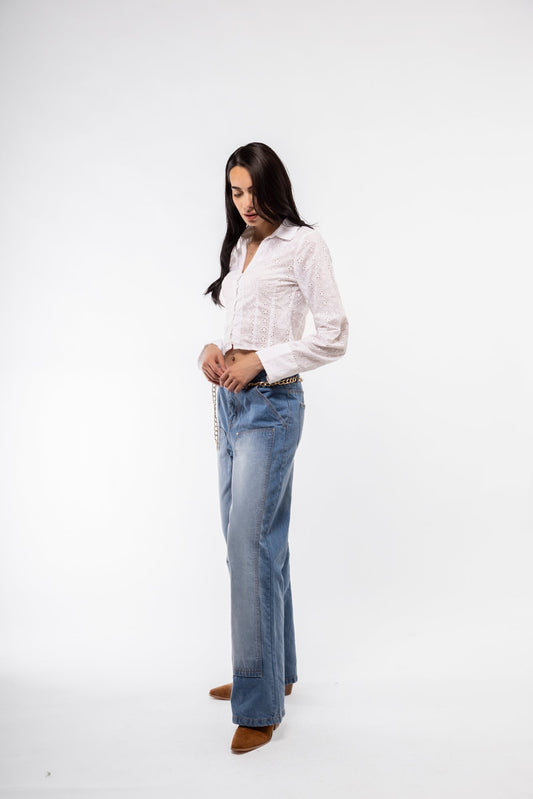 Side profile of white broderie long-sleeve cropped shirt – feminine silhouette

