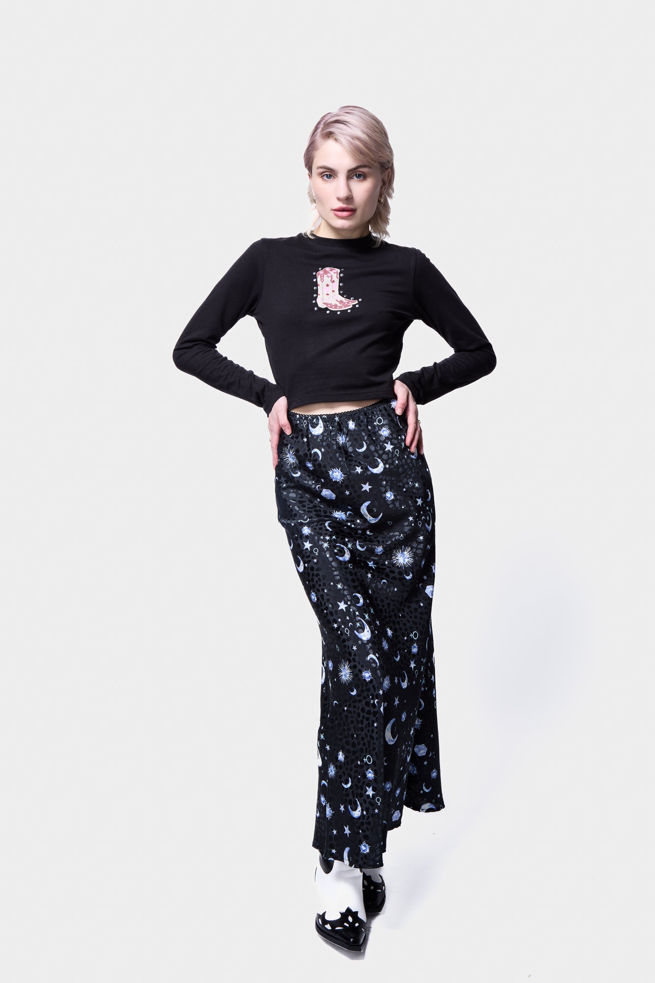 Black long-sleeve top with cowboy boot graphic from Silkroad Daughters